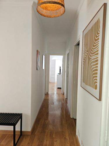 a hallway with white walls and a black bench at Apartamentos Mirador de San Telmo in Tui