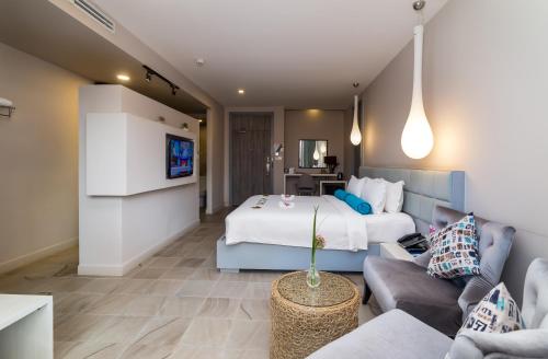 a hotel room with a bed and a couch at Damrei Residence & Spa in Siem Reap
