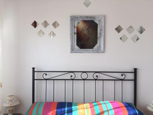 a bedroom with a bed and a mirror on the wall at Holiday Home Gionny & Mary in Taormina