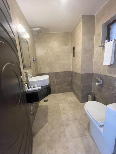 a bathroom with a white toilet and a sink at Mountain Vista Retreat in Nagarkot