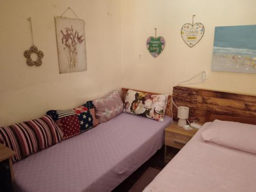 a room with a couch with pillows on it at Apartman Lara in Brodarica