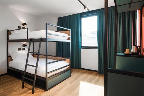 a bedroom with two bunk beds and a window at CX Trieste Giulia in Trieste