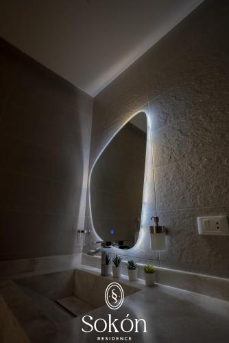 a bathroom with a large mirror and a bath tub at Sokón Residence - Cairo - New Cairo - Madinaty B11 in New cairo
