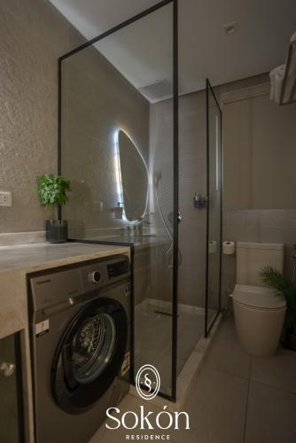 a washing machine in a bathroom with a shower at Sokón Residence - Cairo - New Cairo - Madinaty B11 in New cairo