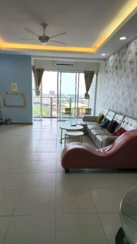 a living room with a couch and a table at Countryside Condo @One Residence Sekinchan in Sekincan
