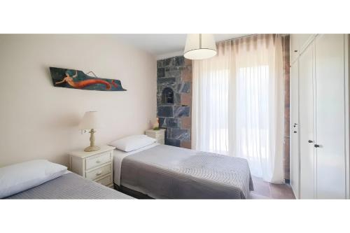 Ένα ή περισσότερα κρεβάτια σε δωμάτιο στο Vitali River House Andros