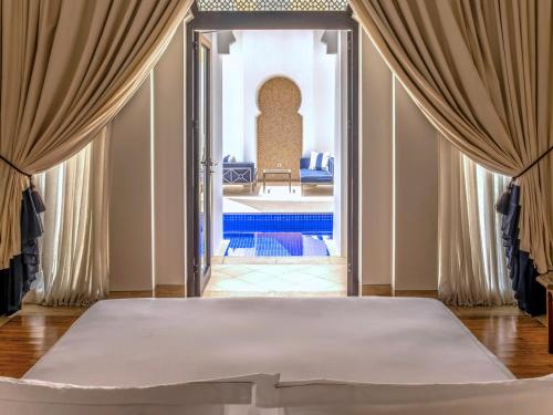 a bedroom with a large bed in a room at Banyan Tree Tamouda Bay in Fnidek