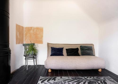 a couch in a room with a plant and a table at MILK HOUSE- Laidi Palace residency in Laidi