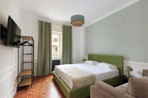 a bedroom with a green bed and a chair at Gramsci Baveno in Baveno
