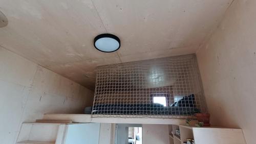 a room with a ceiling with a light on it at Tiny house v ohradě in Čížkov