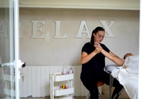 a woman standing next to a bed with a man at Masia Spa Can Pascol Casa Ecologica in Pontons