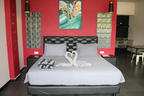 two swans are sitting on a bed in a room at Hillside Lovina in Lovina