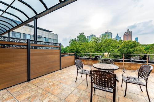 a patio with chairs and a table on a balcony at Holiday Inn Express Nanjing Xi'anmen by IHG in Nanjing