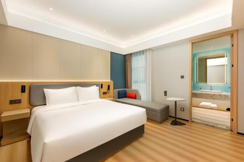 a hotel room with a bed and a bathroom at Holiday Inn Express Nanjing Xi'anmen by IHG in Nanjing