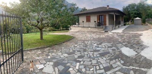 a house with a stone driveway in front of a house at La casa delle Sante in Capo di Ponte