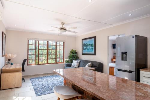 a kitchen and living room with a large counter top at Kingfisher Cove in Ballito