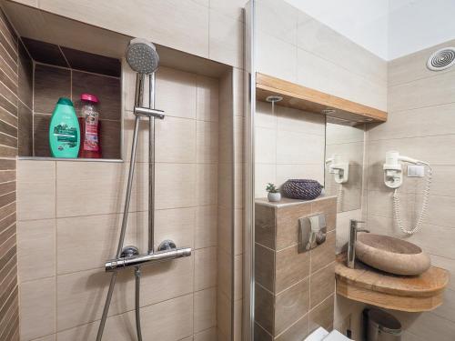 a bathroom with a shower with a toilet and a sink at City Spirit Studio - Piața Mare & Bălcescu View in Sibiu