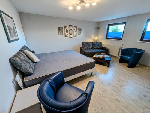 a bedroom with a bed and a living room at Ferienwohnung Suchomski in Baabe