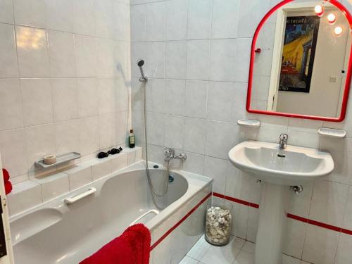 a bathroom with a sink and a tub and a mirror at Deluxe Dream Villa in Għajnsielem