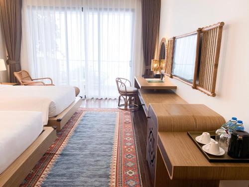 Ένα ή περισσότερα κρεβάτια σε δωμάτιο στο KK Sapa Hotel