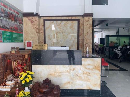 a lobby with a map on the wall and flowers at Love Hotel Hóc Môn in Ho Chi Minh City