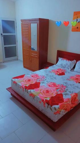 a bedroom with a bed with red roses on it at revalabook in Yof