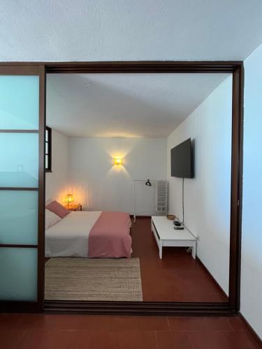 a bedroom with a bed and a large glass window at Casa Oliveira - Algarve in Porches