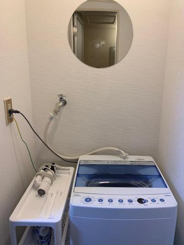 a small bathroom with a sink and a mirror at Zen Abode404 Japanese-style and modern Western-style rooms in Tokyo