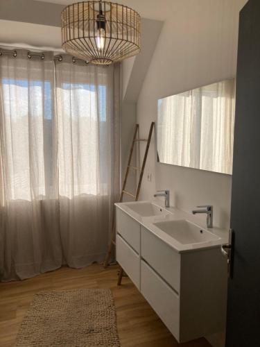 une salle de bain avec un lavabo et un miroir dans l'établissement Eden, à Saint-Martin-des-Champs