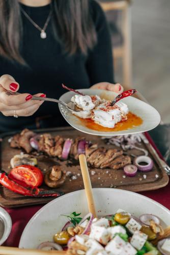 a woman holding a plate with ice cream on it at Leman Otel in Denizli