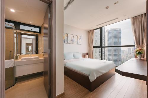 a hotel room with a bed and a bathroom at LUXURY APARTMENT VINHOMES SKYLAKE 5min to KEANGNAM in Hanoi
