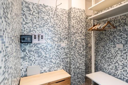 a bathroom with blue and white tiles on the wall at Green Emerald by BarbarHouse in Polignano a Mare