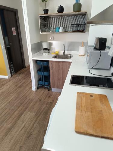 a kitchen with a white counter top and a sink at Apartamentos AL-QAZERES LUXURY La Concepción in Cáceres
