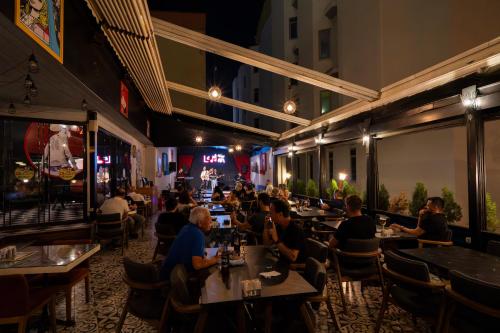 a group of people sitting at tables in a restaurant at Leman Otel in Denizli