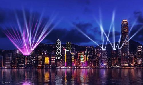 a night view of a city with lights in the water at Smiley Inn in Hong Kong