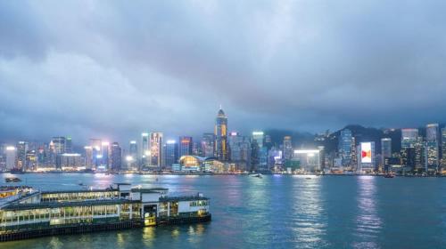 a view of a city at night from the water at Smiley Inn in Hong Kong