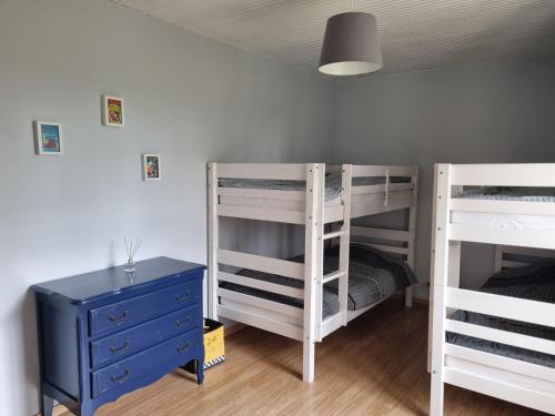 a bedroom with two bunk beds and a blue dresser at Maison en Vendée avec Piscine in Corpe