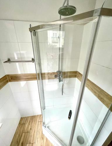 a shower with a glass enclosure in a bathroom at Colourful Rooms Wrocław in Wrocław