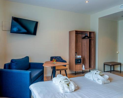 a hotel room with a bed and a couch and a table at Best Western Hotel Karlaplan in Stockholm
