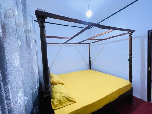 a bed with a canopy in a room at The Villa in Massalapitiya