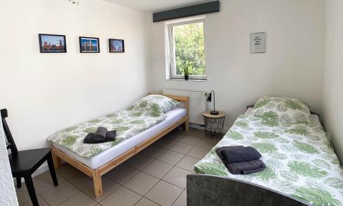 two beds sitting in a room with a window at central working and living apartments in Mechernich