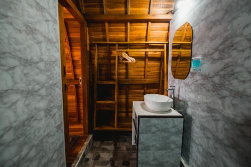 a bathroom with a white sink on a table at The Polumb Garden Bedugul in Tabanan