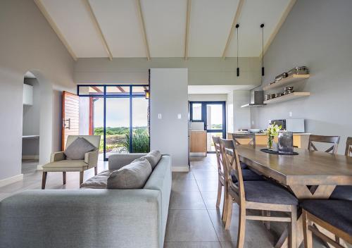 a dining room and kitchen with a table and chairs at Hotel Olivewood in East London