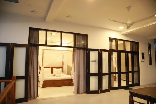 a room with a bedroom with a bed in it at Gold Bubble in Ahangama