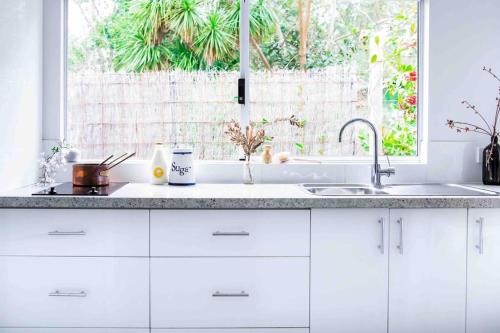 a white kitchen with a sink and a window at Wellness Escape- Near Town & Beach- Sea La Vie in Margaret River Town