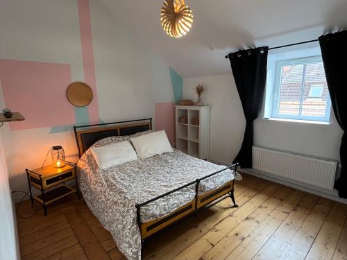 a bedroom with a bed and a window at Maison entière 6 chambres in Saint-André-lez-Lille