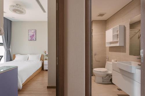 a bathroom with a bed and a toilet and a sink at LUXURY APARTMENT VINHOMES SKYLAKE 5min to KEANGNAM in Hanoi