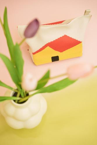 a flower and a box of cake on a table at 寅ホテル 御徒町 TORA HOTEL Okachimachi in Tokyo