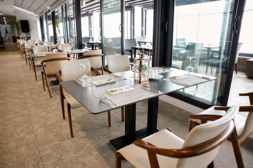 a row of tables and chairs in a restaurant at Atlantis Alger in Alger