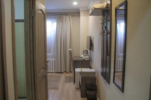 a hallway with a bathroom with a mirror and a desk at Resident Hotel Almaty in Almaty